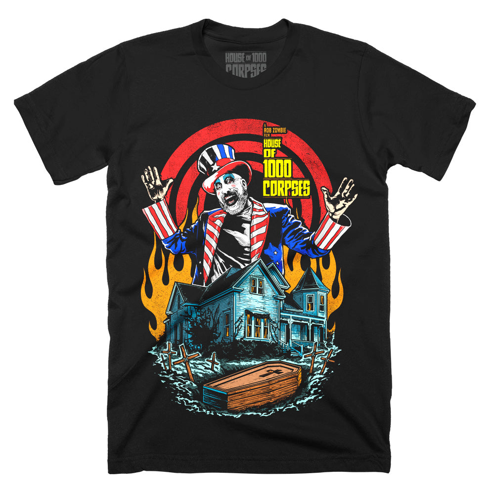 House Of 1000 Corpses Bless This House T-Shirt on black classic Terror Threads tee featuring Captain Spaulding above the Firefly house with flames, graves, and a coffin.