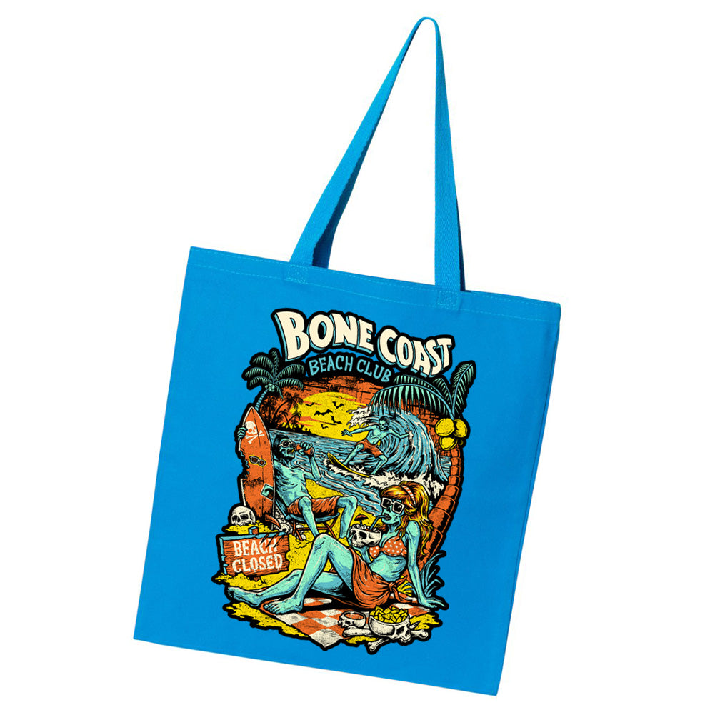Terror Threads Original Bone Coast Beach Club blue tote bag featuring retro tropical horror artwork with undead beachgoers, palm trees, ocean waves, and a beach closed sign.