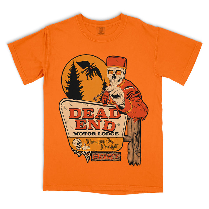 Dead End Motor Lodge original horror graphic Comfort Colors T-shirt in orange featuring a skeletal bellhop, vintage roadside motel sign, full moon and winged creature