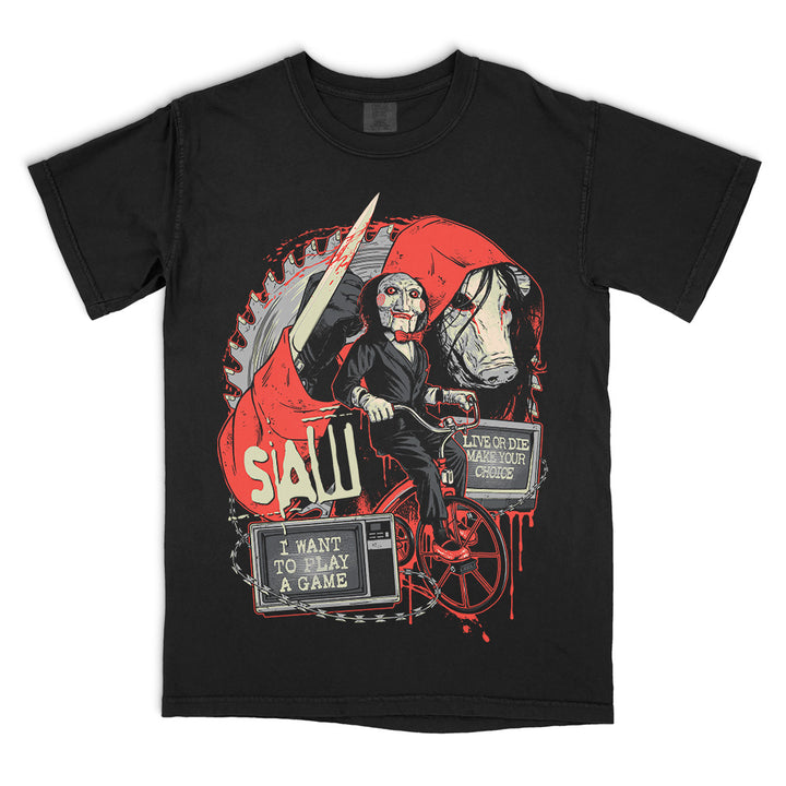 Black Comfort Colors SAW Make Your Choice T-Shirt featuring Billy the Puppet on his tricycle, the pig mask, circular saw blade, knife and blood-red film imagery.