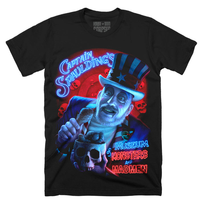 House Of 1000 Corpses “Monsters and Madmen” T-Shirt featuring Captain Spaulding holding a skull with neon Captain Spaulding and Museum of Monsters and Madmen lettering, printed on a black classic fit Terror Threads tee.