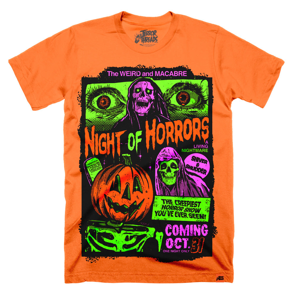 Orange t-shirt featuring a neon retro horror poster-style design with large green eyes at the top, a purple skull figure, a carved jack-o’-lantern, hooded skeleton characters, and bold text reading “Night of Horrors” and “Coming Oct. 31” in green and purple.