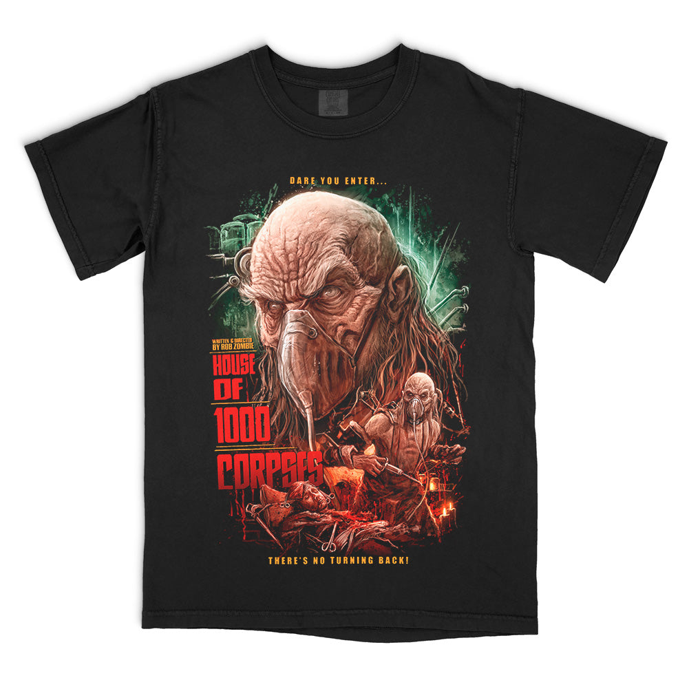 House of 1000 Corpses Satan Is Real T-Shirt on a black Comfort Colors Tee featuring Dr. Satan in a surgical mask with dark underground laboratory imagery