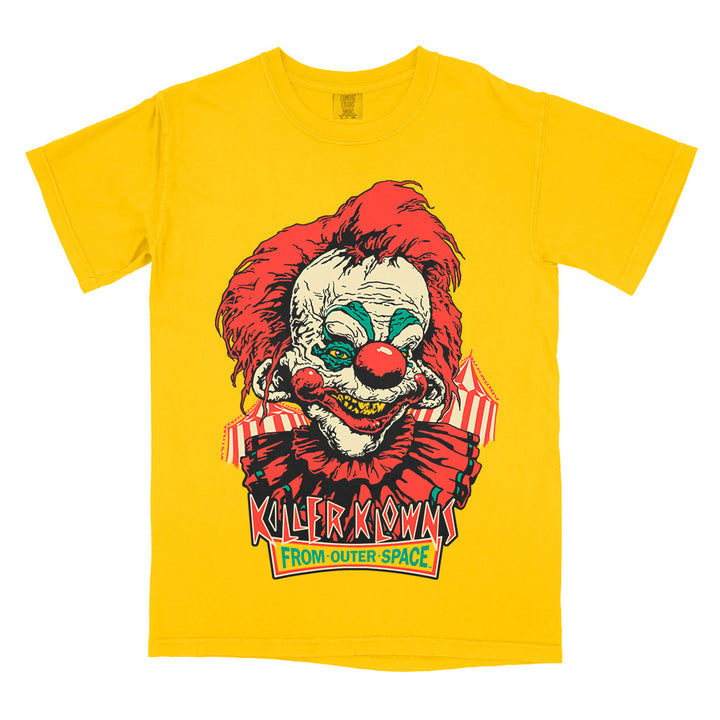 Officially licensed Killer Klowns From Outer Space Step Right Up yellow Comfort Colors t-shirt featuring retro-inspired artwork of a menacing red-haired Killer Klown with a creepy smile and classic movie logo.