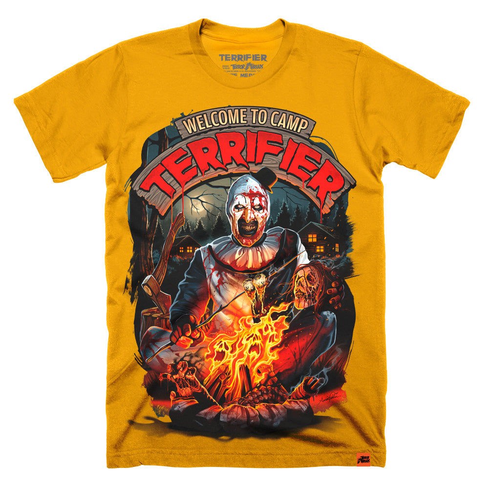 Art the Clown Camp Terrifier horror t-shirt on old gold shirt featuring campfire scene with cabins in the background